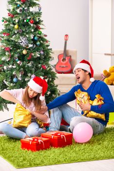 Young couple celebrating christmas at home