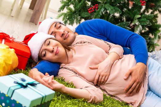 Pregnant wife celevrating christmas with husband