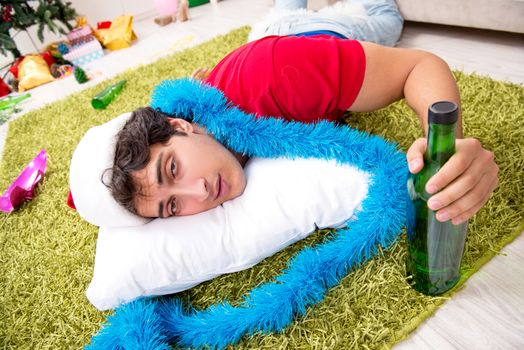 Young man drunk at home after christmas party