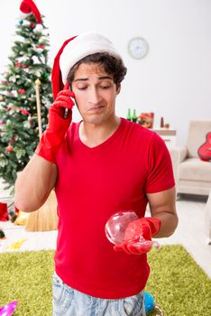 Man cleaning his apartment after christmas party