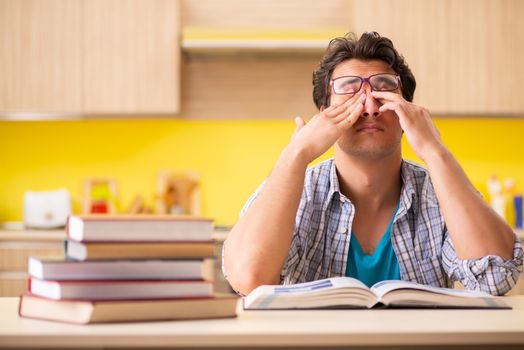 Student preparing for exam sitting at the kitchen 