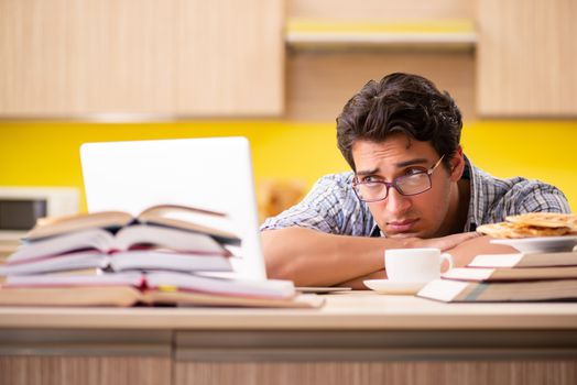 Student preparing for exam sitting at the kitchen 