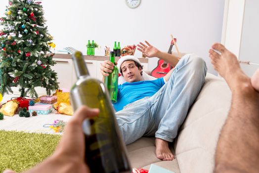 Young man drunk at home after christmas party