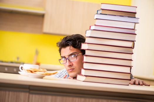 Student preparing for exam sitting at the kitchen 
