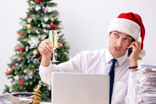 Young worker working in office on christmas shift