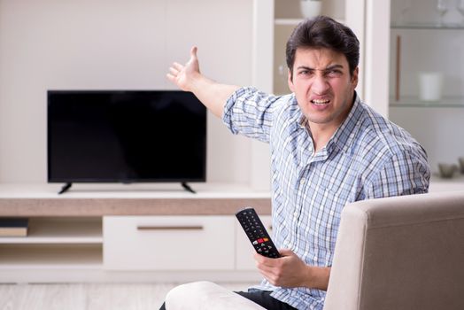 Man trying to fix broken tv