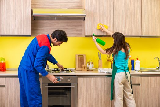 Woman with contractor at kitchen discussing repair