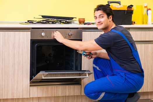 Young service contractor assembling kitchen furniture