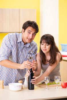 Young couple celebrating wedding anniversary at kitchen 