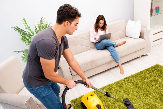 Cleaning the house with vacuum cleaner