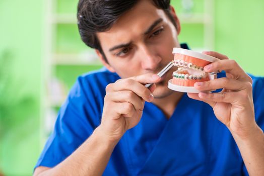 Man dentist working on new teeth implant 