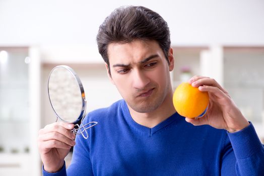Young handsome man taking care of face skin