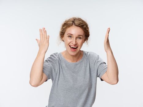 Elderly woman emotions gestures with hands gray t-shirt lifestyle