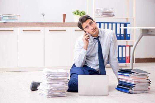 Extremely busy employee working in the office
