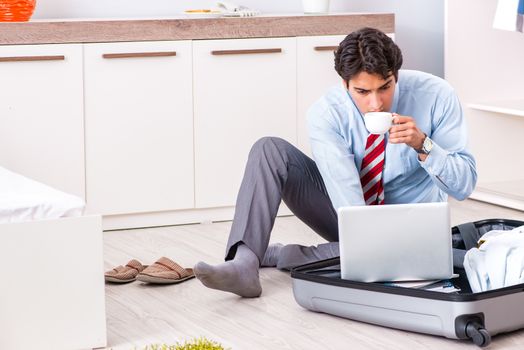 Young handsome businessman preparing for trip