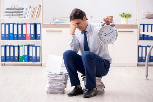 Extremely busy employee working in the office