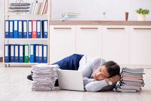 Extremely busy employee working in the office