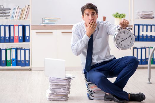 Extremely busy employee working in the office