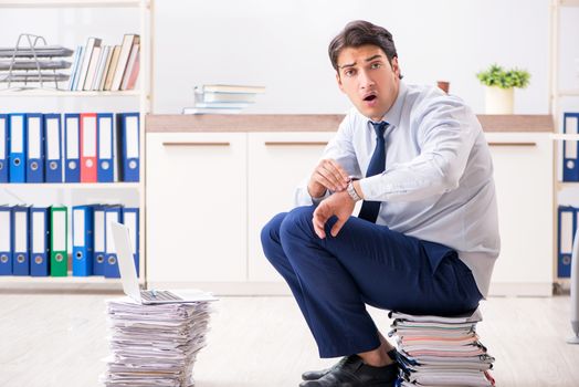 Extremely busy employee working in the office