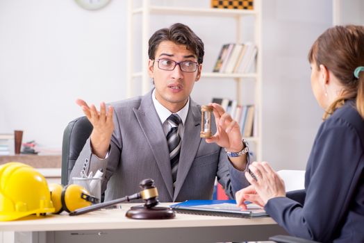 Lawyer talking to client in office