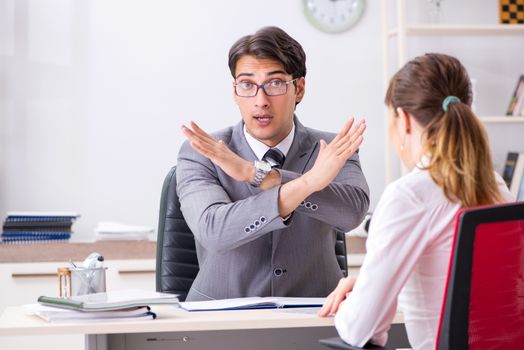 Man and woman discussing in office