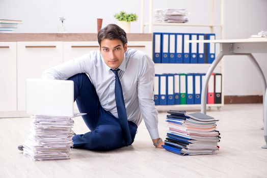 Extremely busy employee working in the office