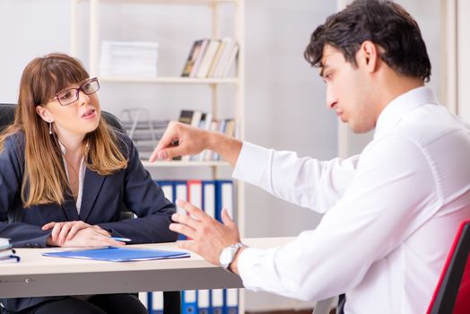 Man and woman discussing in office
