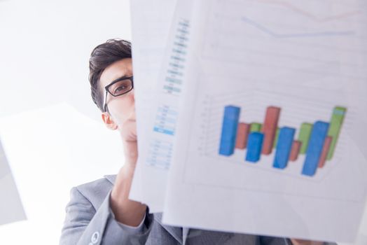 Businessman looking at financial charts and graphs