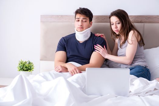 Loving wife taking care of injured husband in bed