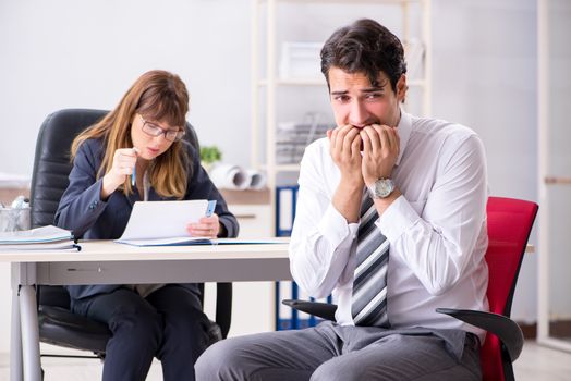 Man and woman discussing in office