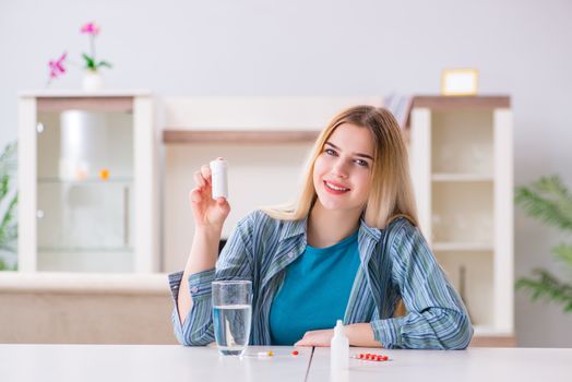 Woman taking pills to cope with pain