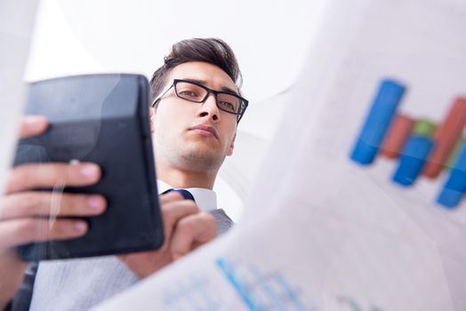 Businessman looking at financial charts and graphs