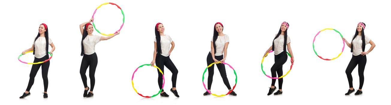 A girl in sport suit with hula hoop isolated on white