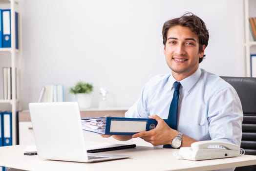 Young handsome businessman working in office