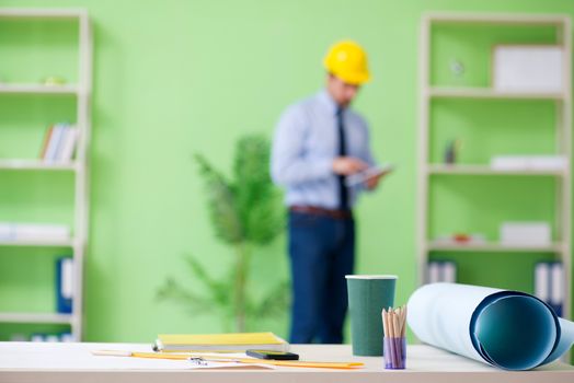 Young male architect working at the project