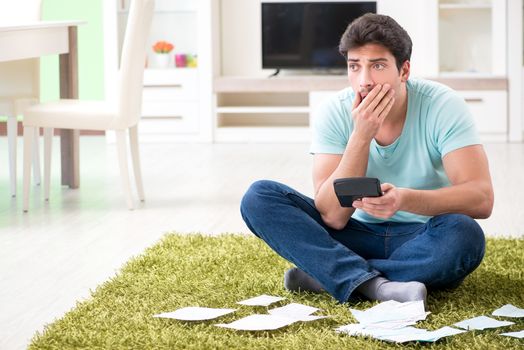 Young man struggling with personal finance and bills