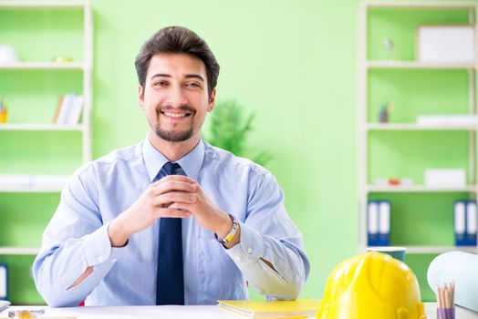 Young male architect working at the project