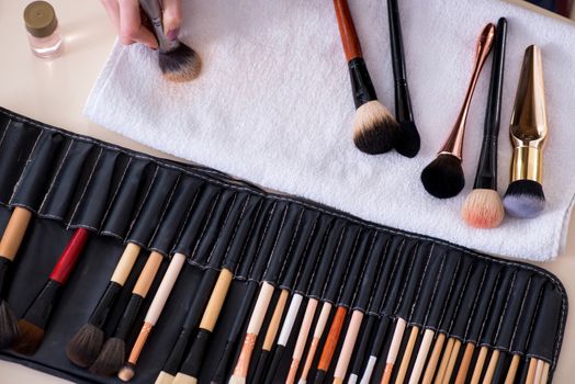 Make-up artist preparing brushes for work