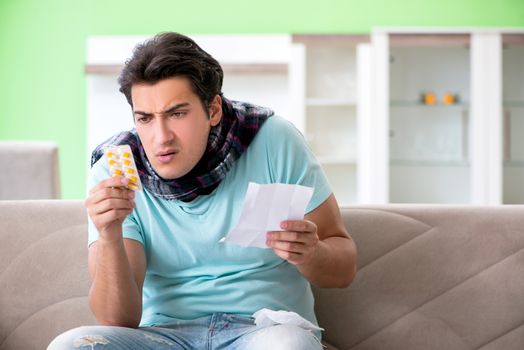Young handsome man suffering from illness at home 