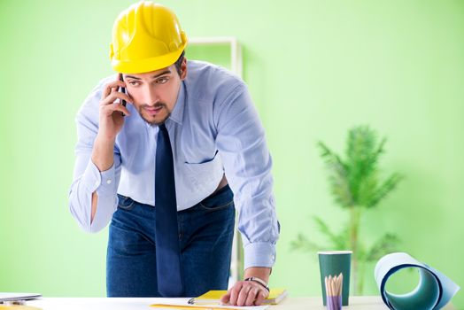 Young male architect working at the project
