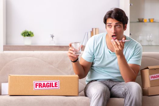 Man opening fragile parcel ordered from internet