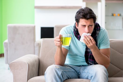 Young handsome man suffering from illness at home 