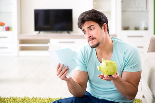 Young man struggling with personal finance and bills