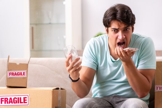 Man opening fragile parcel ordered from internet