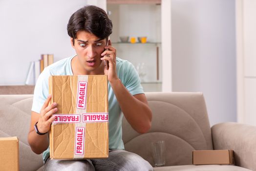 Man opening fragile parcel ordered from internet