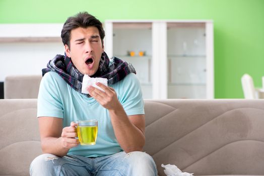 Young handsome man suffering from illness at home 