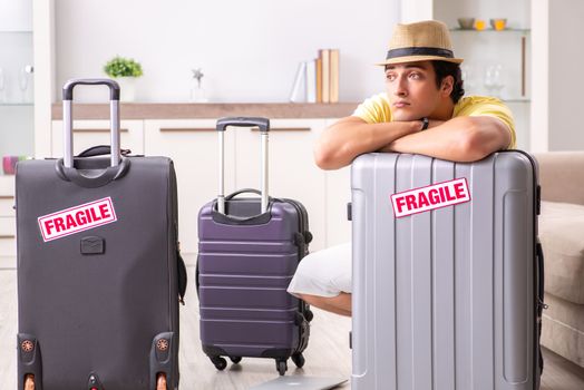 Man going on vacation with fragile suitcases