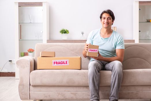 Man opening fragile parcel ordered from internet