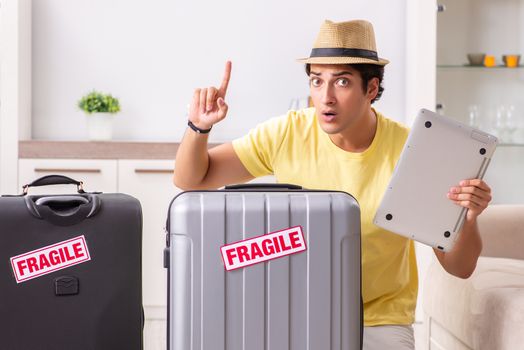 Man going on vacation with fragile suitcases