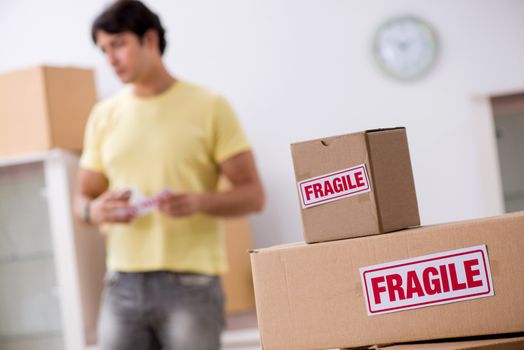 Man moving house and relocating with fragile items